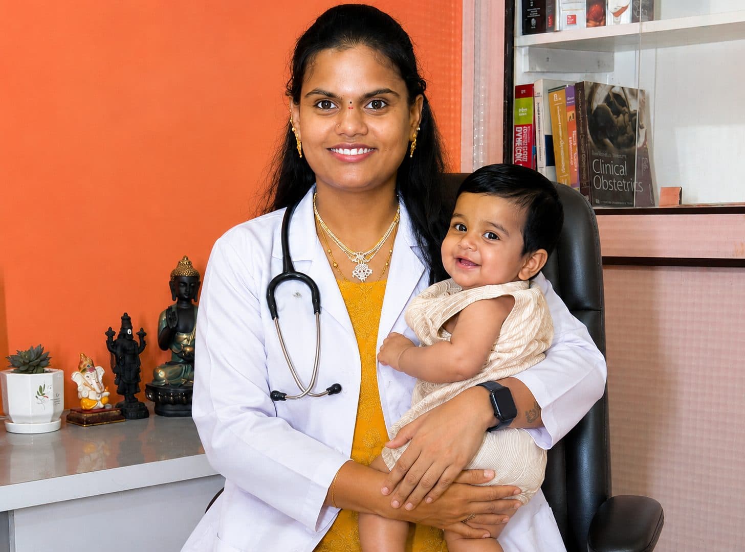 Fertility specialist Dr. S Mounika Reddy holding a smiling baby