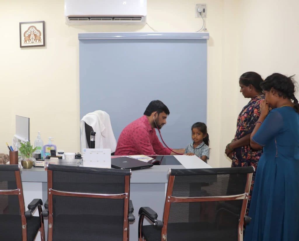 Paediatrician seeing a child and parent at Dhruva Hospitals